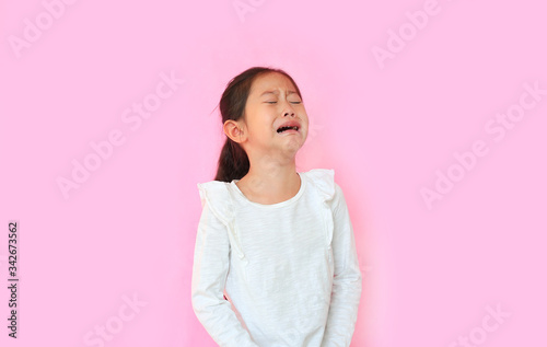 Wallpaper Mural Portrait asian little child girl crying isolated on pink background with copy space