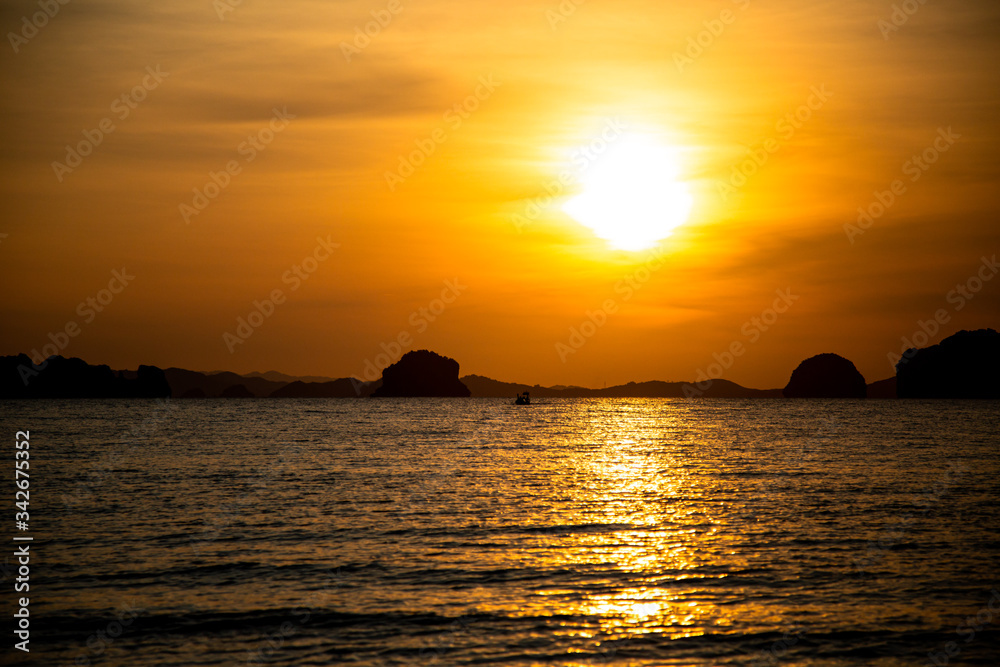 Beautiful sunset on the beach with islands