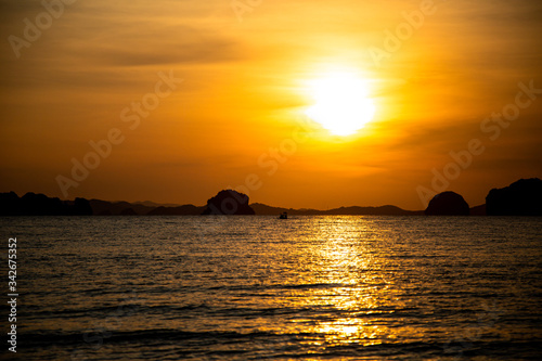 Beautiful sunset on the beach with islands