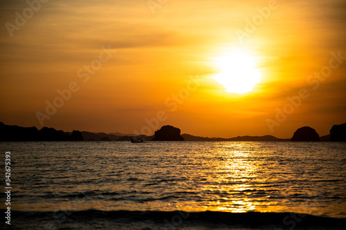 Beautiful sunset on the beach with islands © vgatto