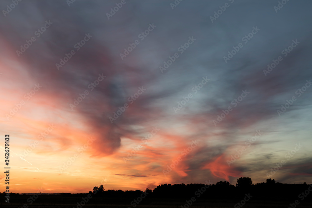 Dramatic sunset clouds in vibrant colors / landscape at dusk / cloud formation at sunrise / dreamy sky and cloudscape