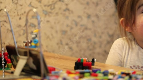 Covid-19 Coronavirus and Learning from home. Little girl online learning and creating at home. Quarantine and Social distancing concept.