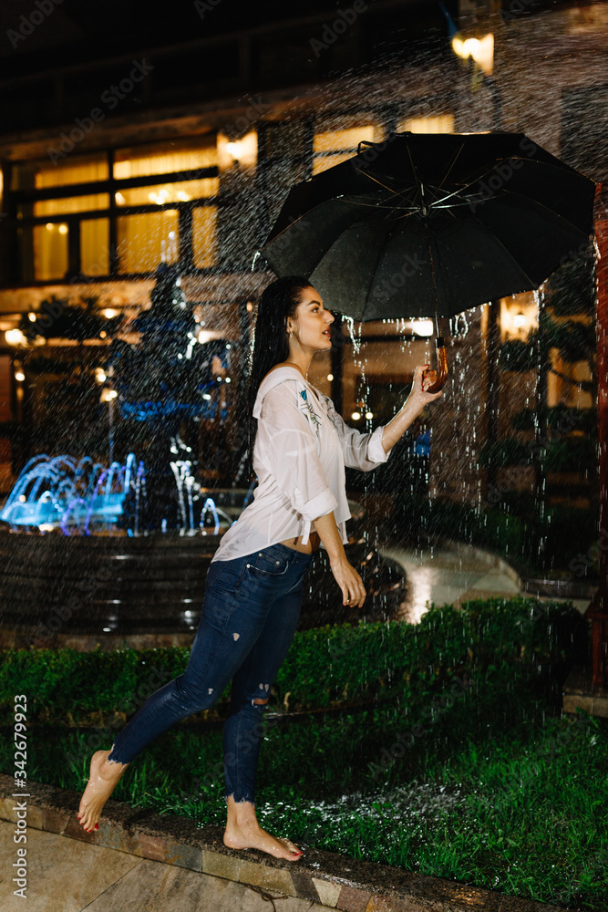 Obraz premium Laughing woman with umbrella checking for rain