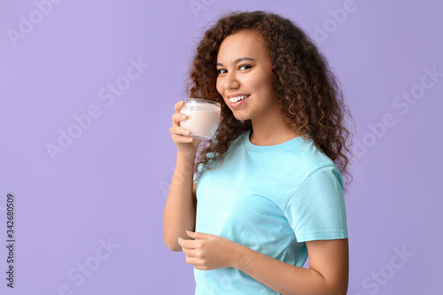 Young woman with tasty yogu...