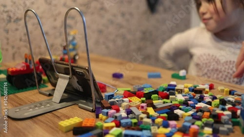 Covid-19 Coronavirus and Learning from home. Little girl online learning and creating at home. Quarantine and Social distancing concept.