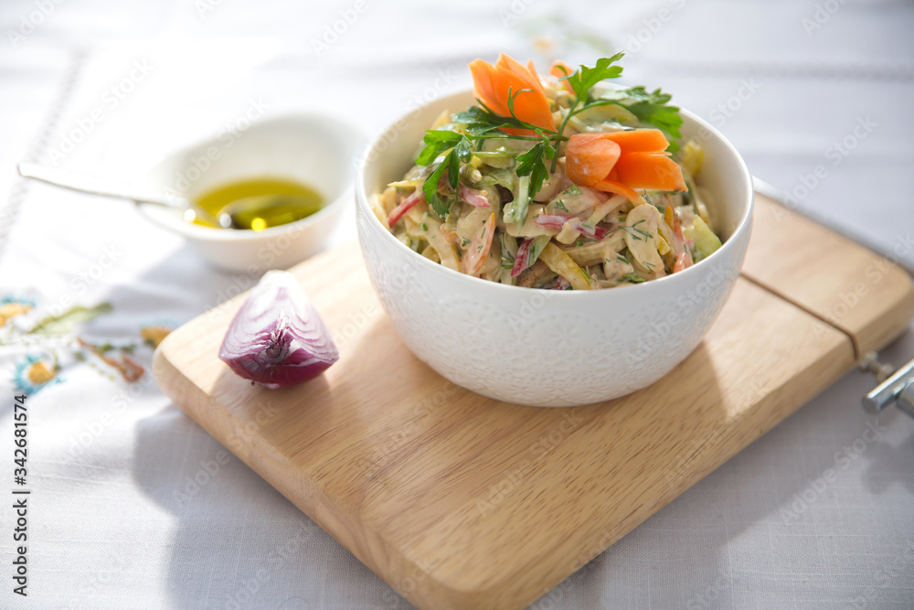 Chopped red onion . olives on a small white bowl . wooden board . Salad with ham, red and orange pepper, mushrooms, pickles, white sauce, on a white bowl and olives. Chopped red onion . olives on a small white bowl . wooden board . Salad with ham, red and orange pepper, mushrooms, pickles, white sauce, on a white bowl and olives.