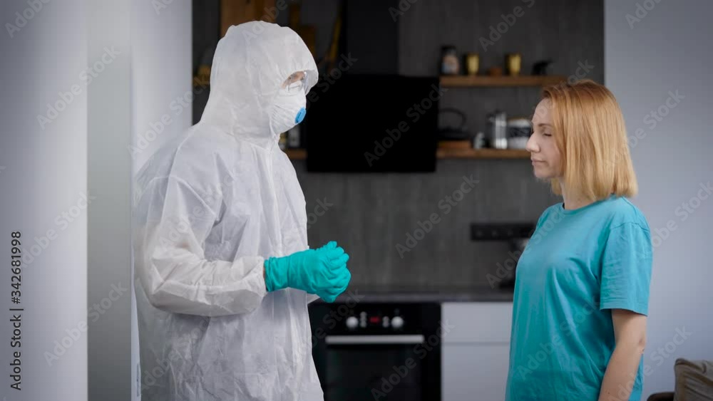 Pandemic Covid-19. The doctor takes the test in a person infected with the virus. A woman at home, doing a test for a dangerous pathogen. Pandemic Covid-19. The doctor takes the test in a person infected with the virus. A woman at home, doing a test for a dangerous pathogen.