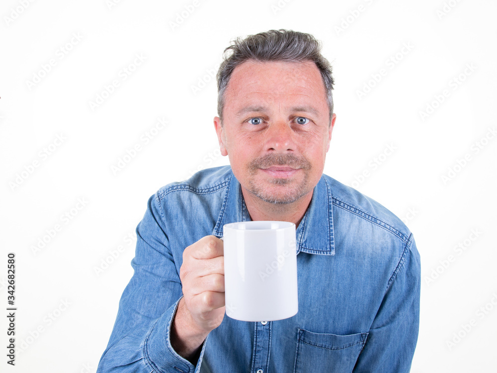 handsome hipster man holding presenting blank mug cup of coffee isolated over white background handsome hipster man holding presenting blank mug cup of coffee isolated over white background