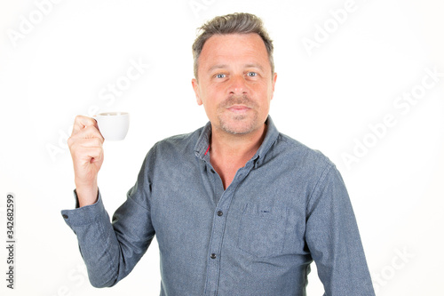 businessman handsome attractive man wearing blue shirt drinking hot drink coffee from cup isolated over white background