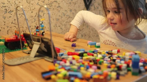 Covid-19 Coronavirus and Learning from home. Little girl online learning and creating at home. Quarantine and Social distancing concept.