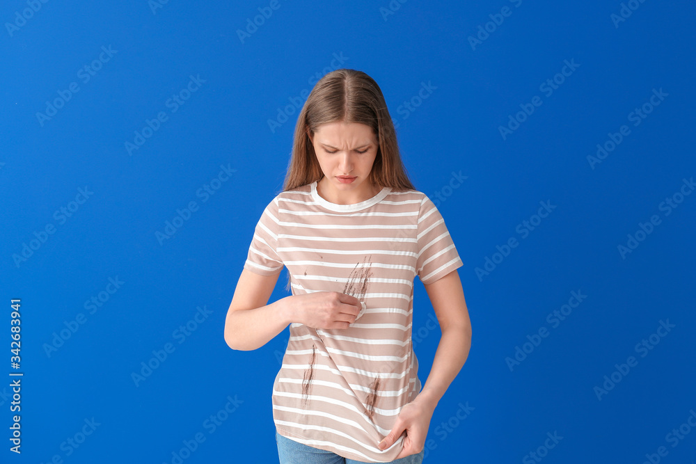 Troubled woman in dirty clothes and with napkin on color background Troubled woman in dirty clothes and with napkin on color background