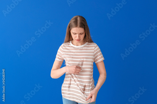 Troubled woman in dirty clo...