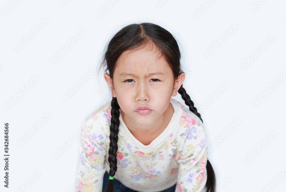 Funny face not satisfied of asian little child girl on white background. Close-up shot. Funny face not satisfied of asian little child girl on white background. Close-up shot.