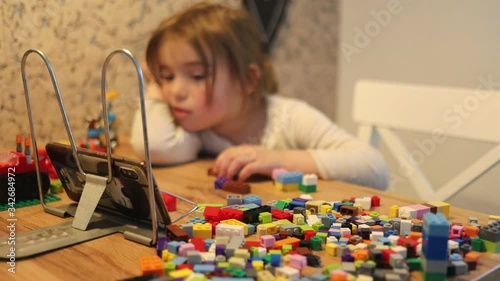 Covid-19 Coronavirus and Learning from home. Little girl online learning and creating at home. Quarantine and Social distancing concept.