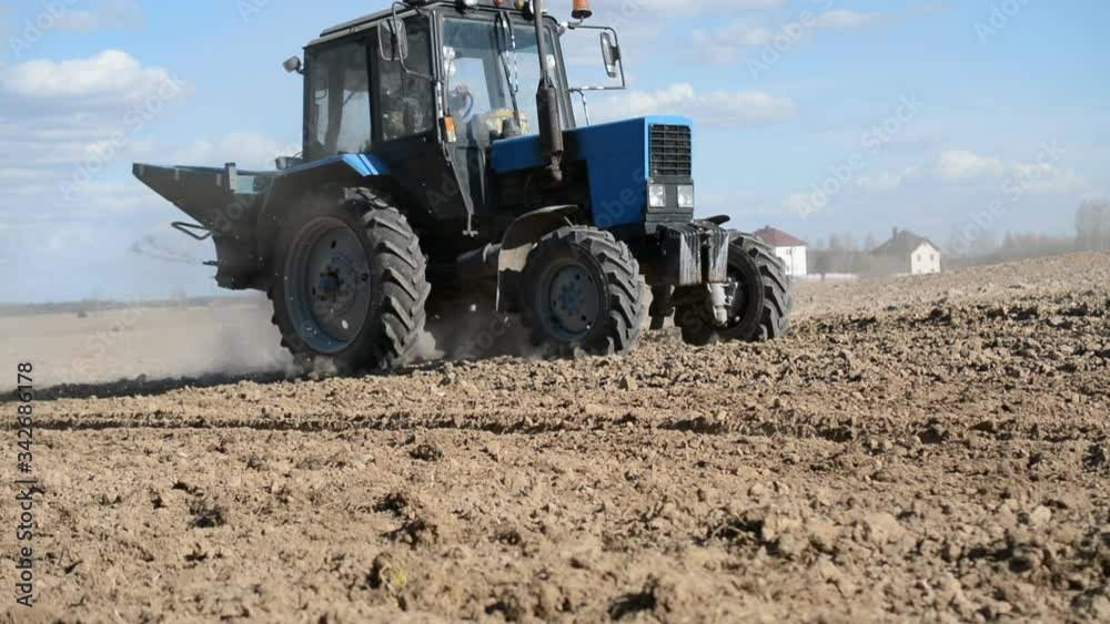 Tractor with fertilizer in the field Tractor with fertilizer in the field