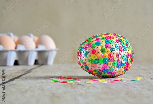 Decorating Easter egg , egg made of colorful , sparkle sequins and pin , happy spring time and fun