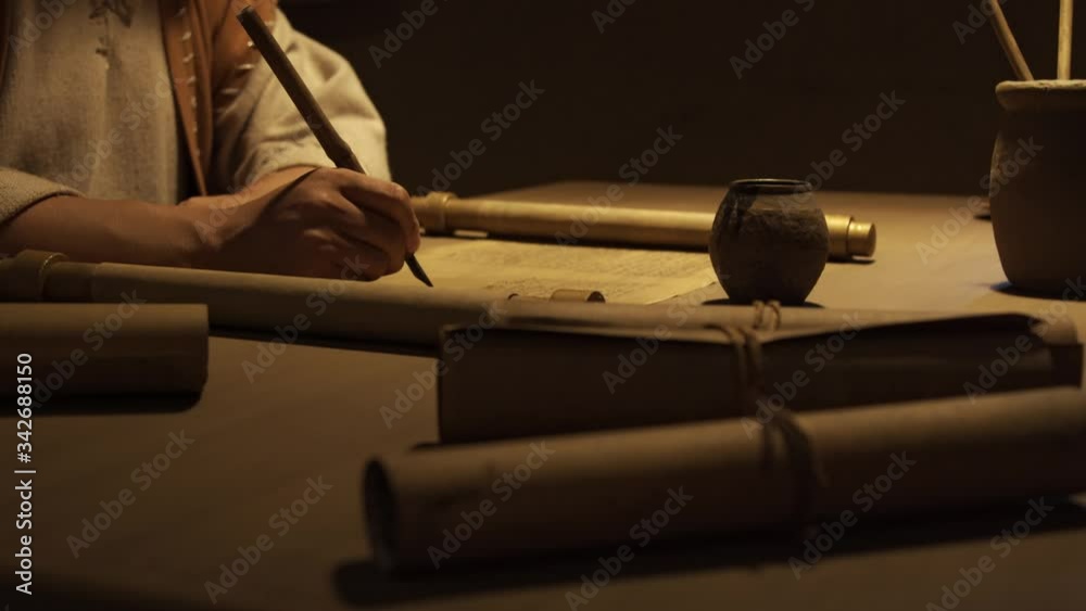 Closeup of writing a letter on ancient paper, ancient scrolls