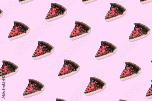 Flat lay colorful pattern with piece of blueberry cake on pastel pink background. Trendy mockup or wallpaper. Minimal tasty food concept with sharp shadows.