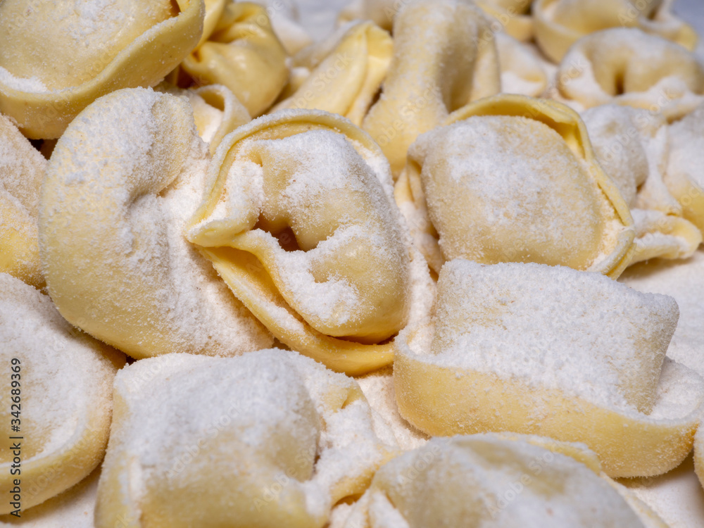 Delicious tortellini a ring-shaped pasta from Italy. Traditionally they are stuffed with a mix of meat, parmigiano reggiano cheese, egg and nutmeg