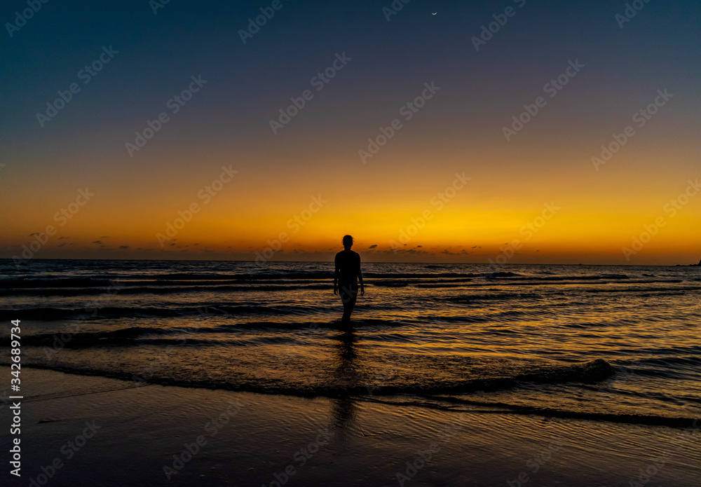 A silhouette of a lady with the sunset sea background at Koh Ta Kiev, Cambodia