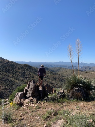 Man standing on the ledge of desert canyon