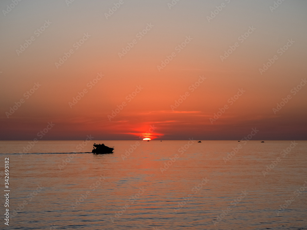 Pleasure boat against the backdrop of a beautiful sea sunset