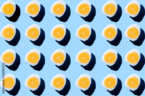 Pattern made of eggs on pastel blue background. Minimal food concept.