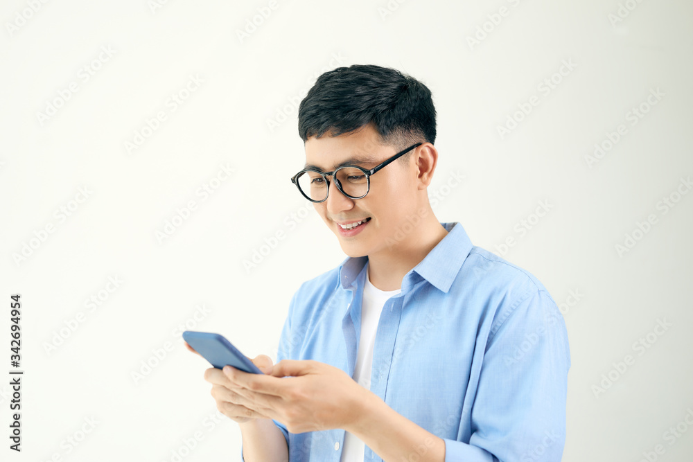 Attractive young man with smartphone on white background Attractive young man with smartphone on white background