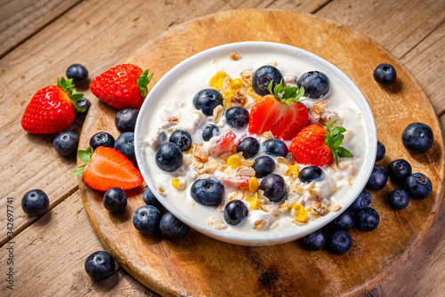 Yogurt with granola, strawberries and blueberries.