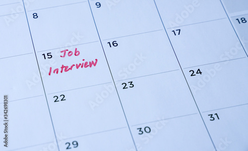 Job interview words written on table calendar with red marker
