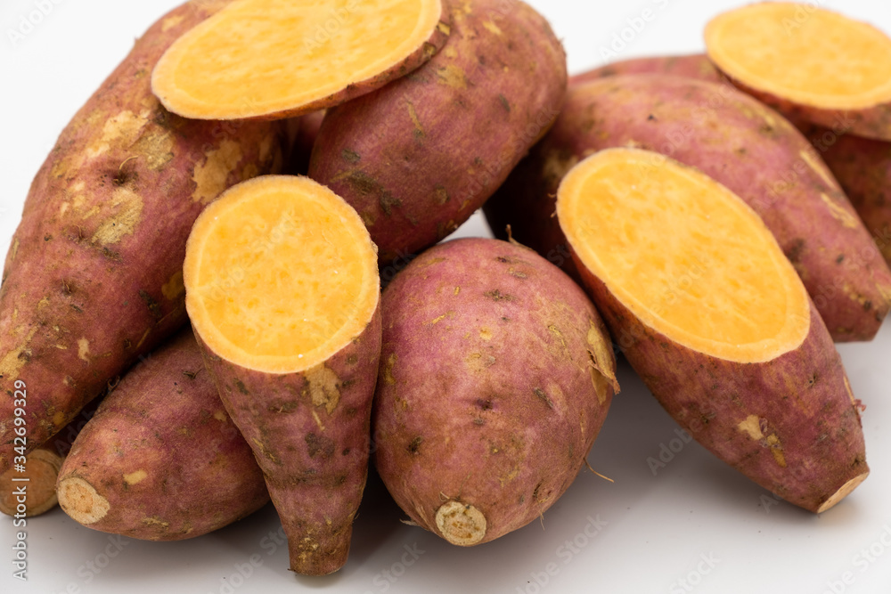 Pile of Japanese potato with yellow sliced texture isolated on white background Pile of Japanese potato with yellow sliced texture isolated on white background