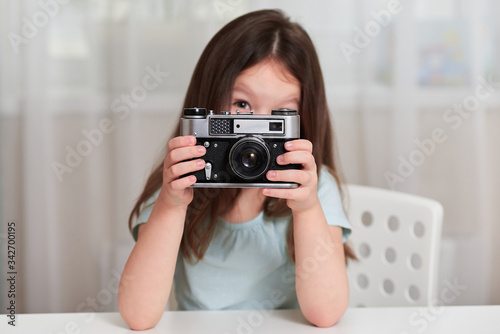 A little girl with an old camera