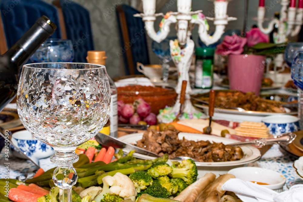 Closeup shot of a wine glass with blurry dinner background