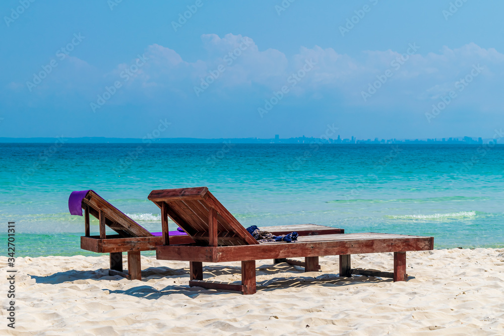 A couple of beach chairs on the beach at the Coconut Beach, Koh Rong, Cambodia