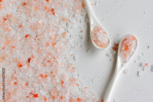 Close up view of white spoons with pink himalayan salt