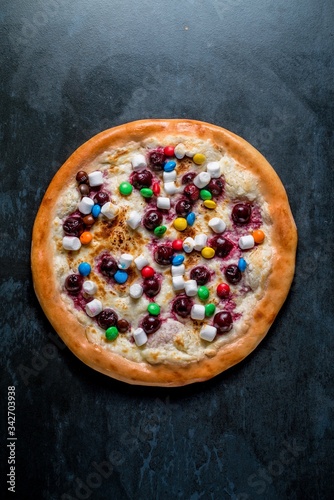 Dessert italian pizza with sauce candy and marshmallows top view