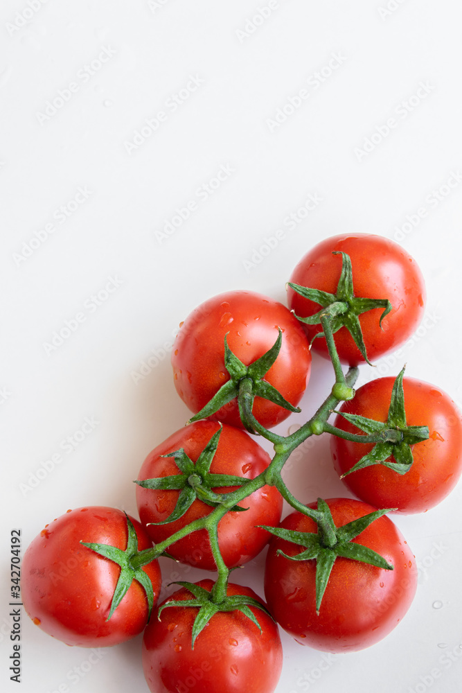 Healthy food ingredient - raw tomatoes on white background, vibrant colours, vitamin food, space for text Healthy food ingredient - raw tomatoes on white background, vibrant colours, vitamin food, space for text