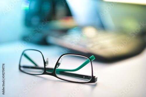 Close up image of eyeglasses on the desk