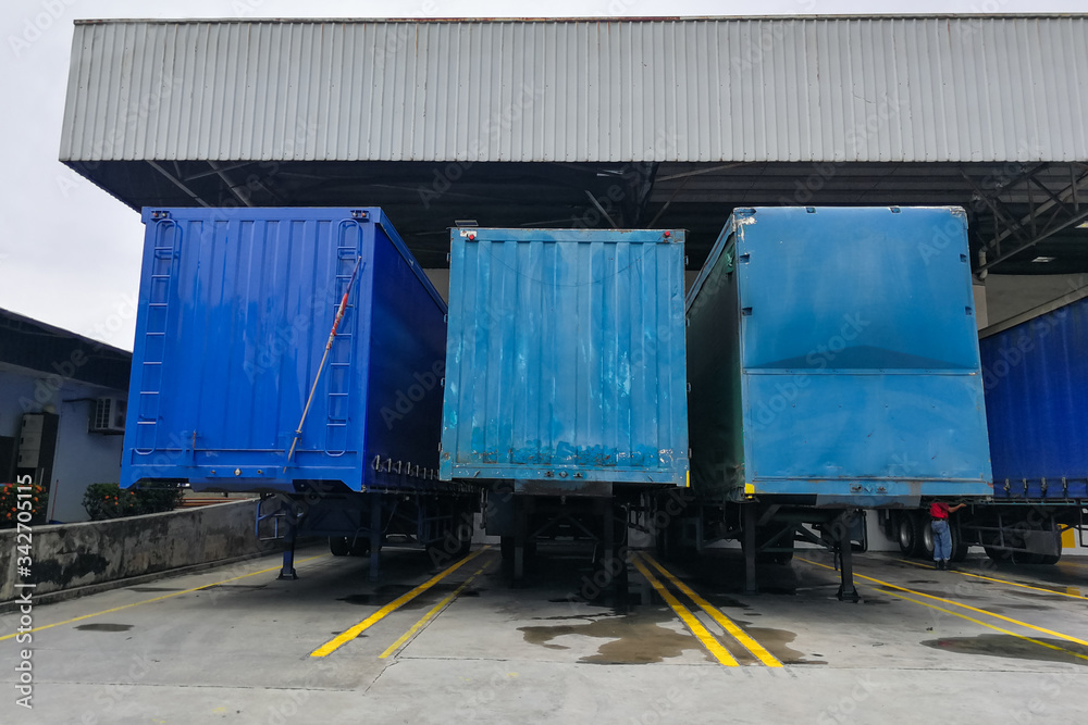 Container box docked at warehouse to load and unload goods for delivery Container box docked at warehouse to load and unload goods for delivery