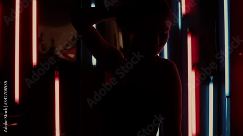 Sensual woman under neon illumination
