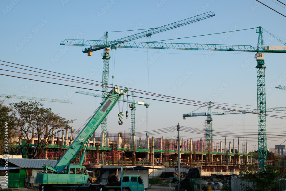 Building construction with crane against blue sky background