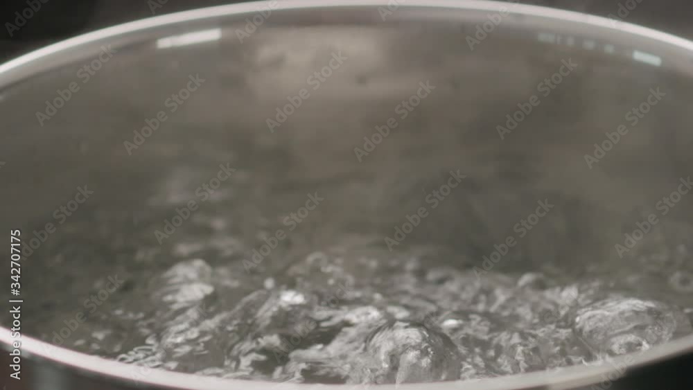Slow motion handheld shot of boiling water in pot closeup Slow motion handheld shot of boiling water in pot closeup