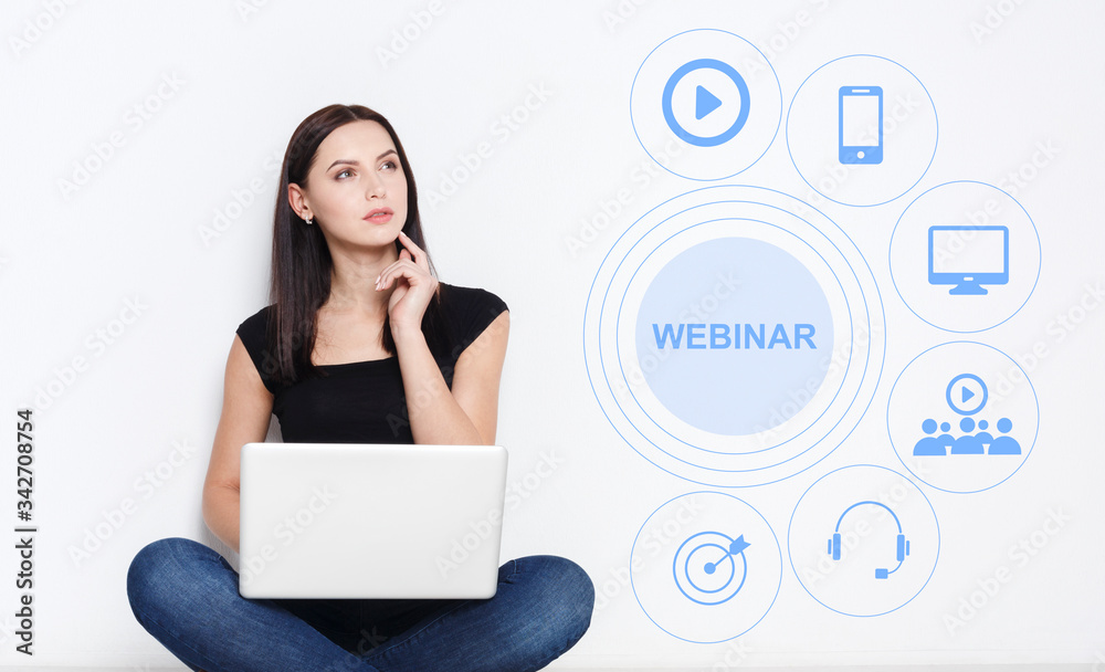 Thoughtful young girl using laptop for remote learning, word WEBINAR and educational icons on screen, collage Thoughtful young girl using laptop for remote learning, word WEBINAR and educational icons on screen, collage