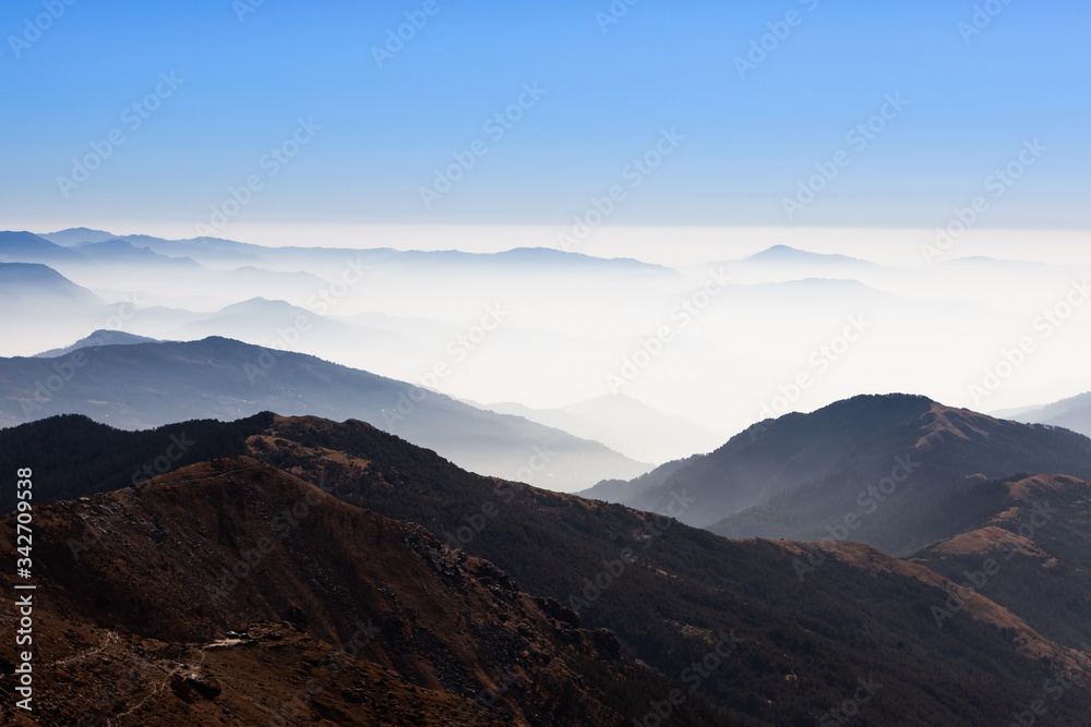 Mountain landscape in morning mist. Foggy hills in Himalayas. Beautiful view from PK (Pikey) Peak in Nepal.