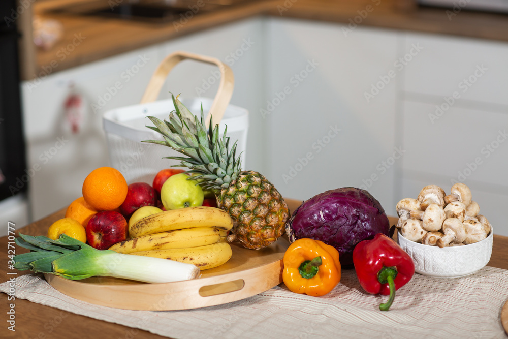 Healthy food clean eating selection in wooden tray : fruit, vegetable, leaf vegetable on white background. Selection of healthy food. Clean eating concept. Organic food concept. Modern kitchen Healthy food clean eating selection in wooden tray : fruit, vegetable, leaf vegetable on white background. Selection of healthy food. Clean eating concept. Organic food concept. Modern kitchen