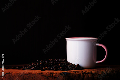 close up coffee cup and coffee beans on wood table