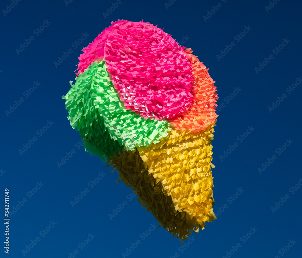 Handmade pinata in the shape of ice cream, colored with neon colors Photos  | Adobe Stock