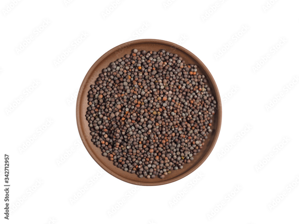Spice mustard seeds on brown clay plate isolated on white Spice mustard seeds on brown clay plate isolated on white