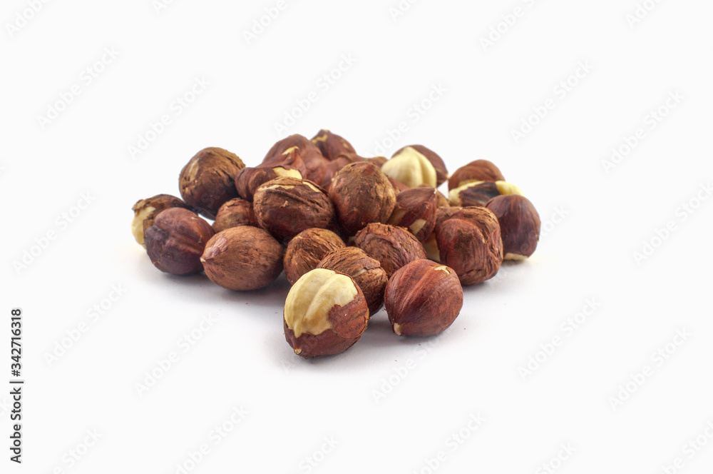 A few hazelnuts isolated on a white background. Well suited for baking or in healthy muesli. A few hazelnuts isolated on a white background. Well suited for baking or in healthy muesli.