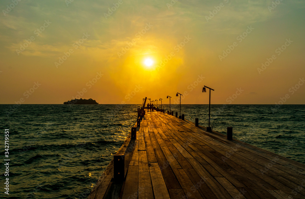 A pier with the sunrise in the background from the White Beach, Koh Rong, Cambodia